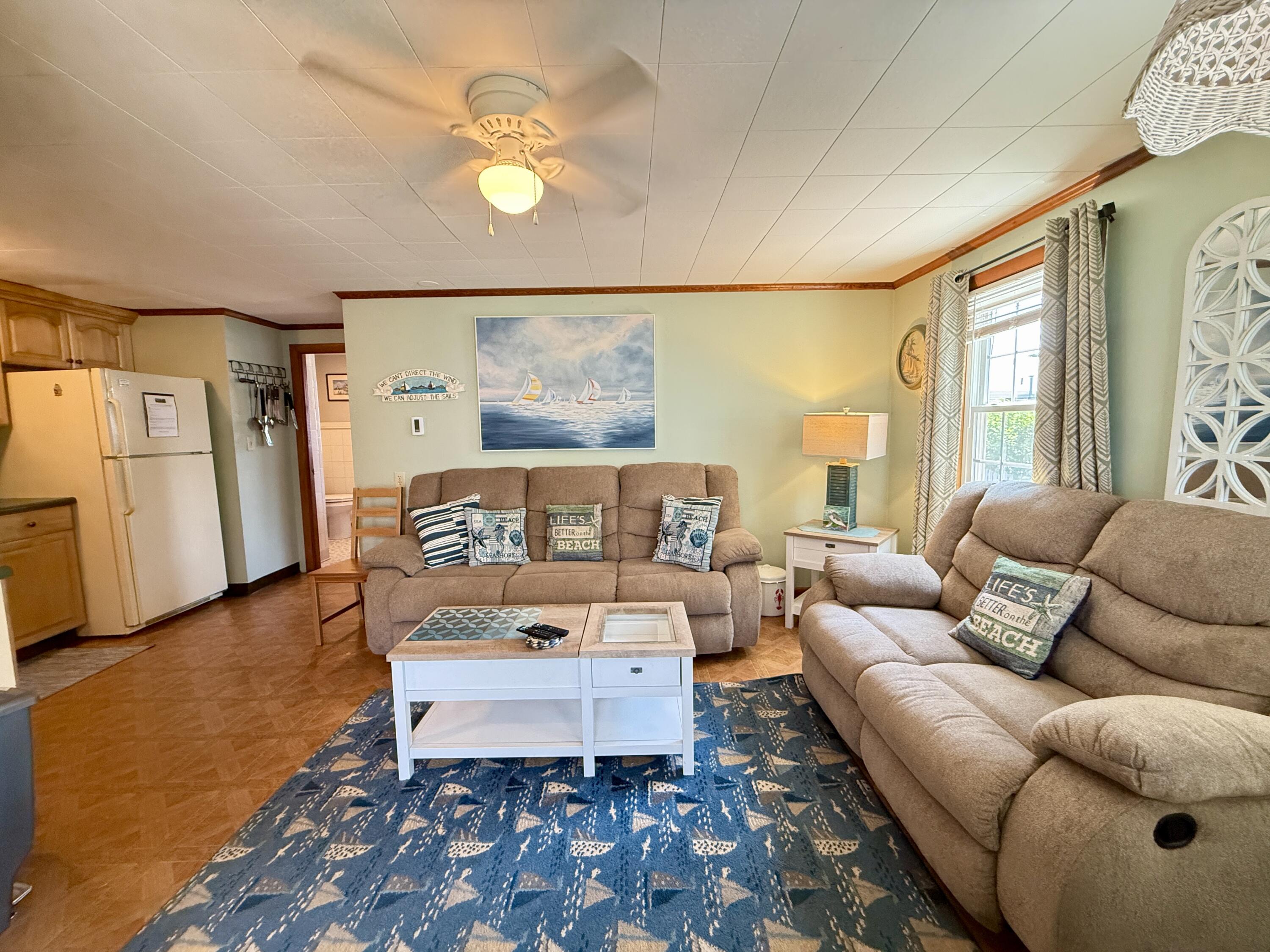 56-58 Uncle Rolf Road Dennis Port, MA 02639 - Photo 23 of 44 a living room with furniture and a rug