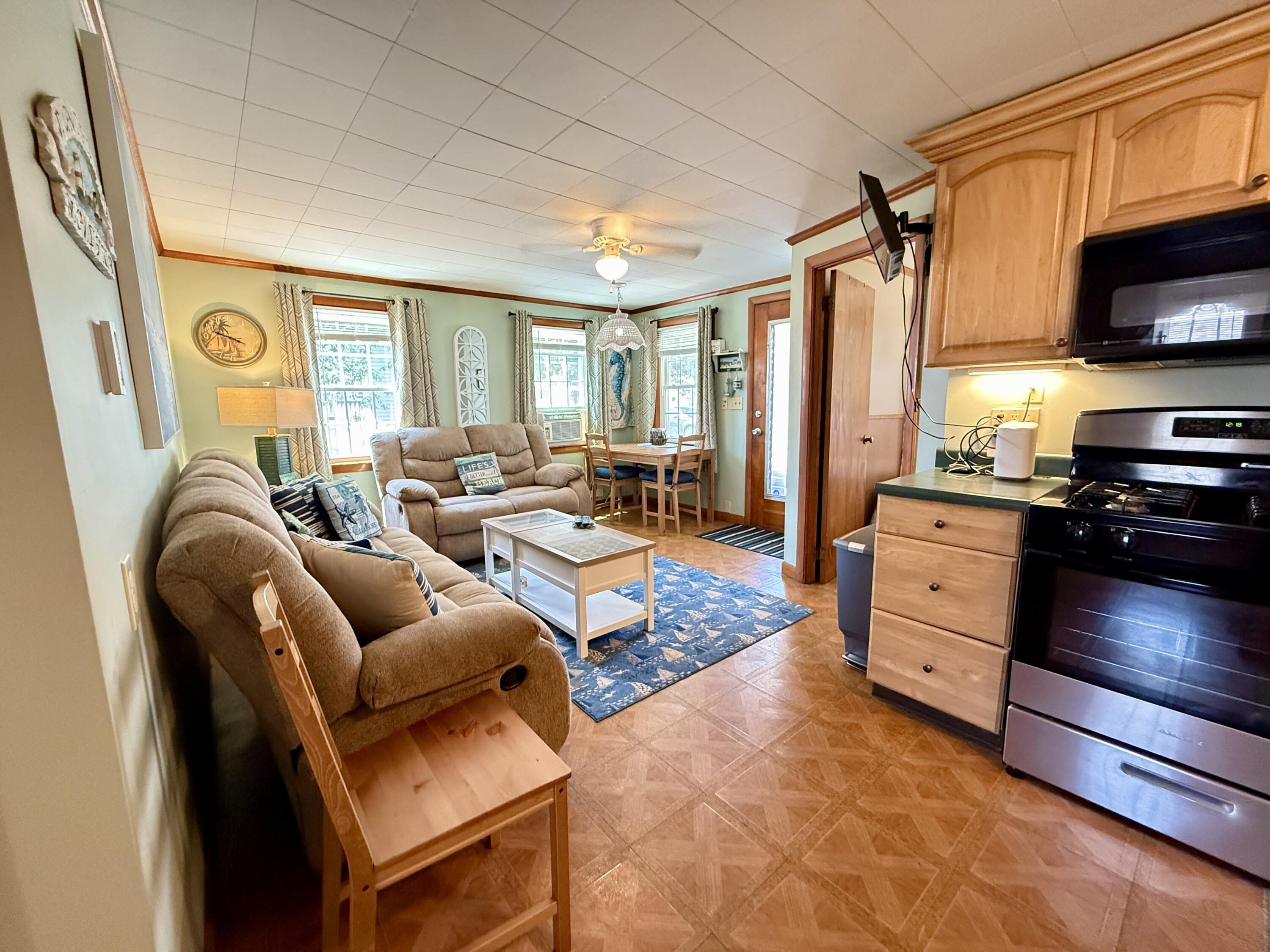 56-58 Uncle Rolf Road Dennis Port, MA 02639 - Photo 30 of 44 a living room with furniture a flat screen tv and a window