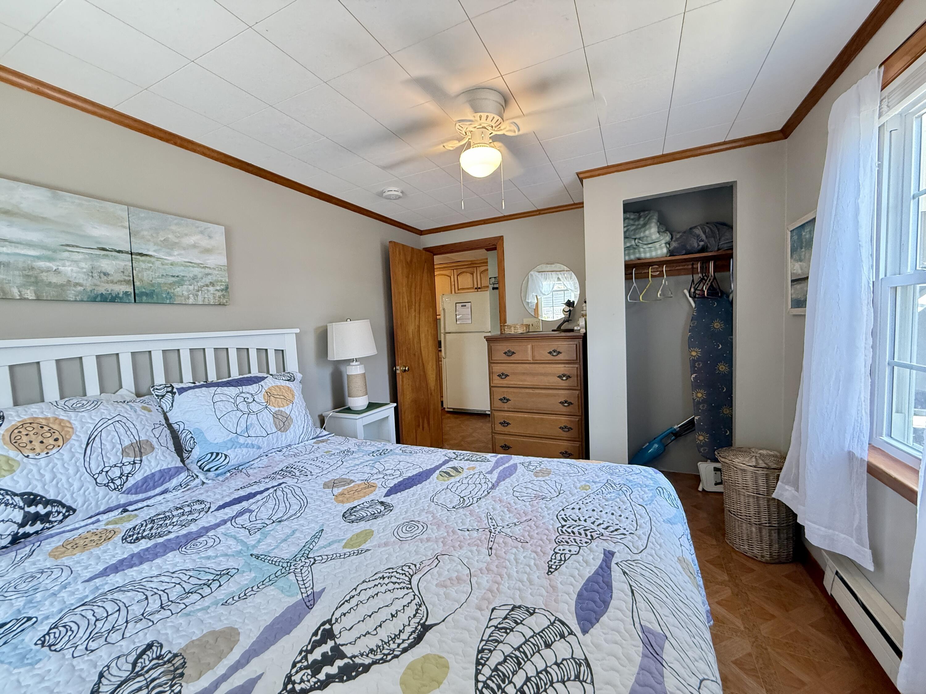 56-58 Uncle Rolf Road Dennis Port, MA 02639 - Photo 33 of 44 a bedroom with a large bed and a chandelier