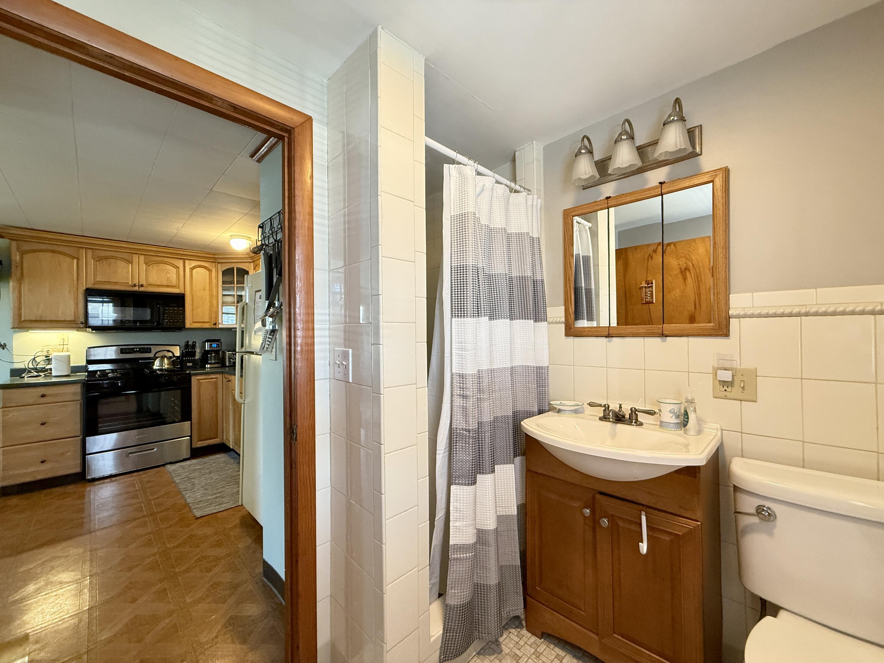 56-58 Uncle Rolf Road Dennis Port, MA 02639 - Photo 37 of 44 a bathroom with a sink and a mirror