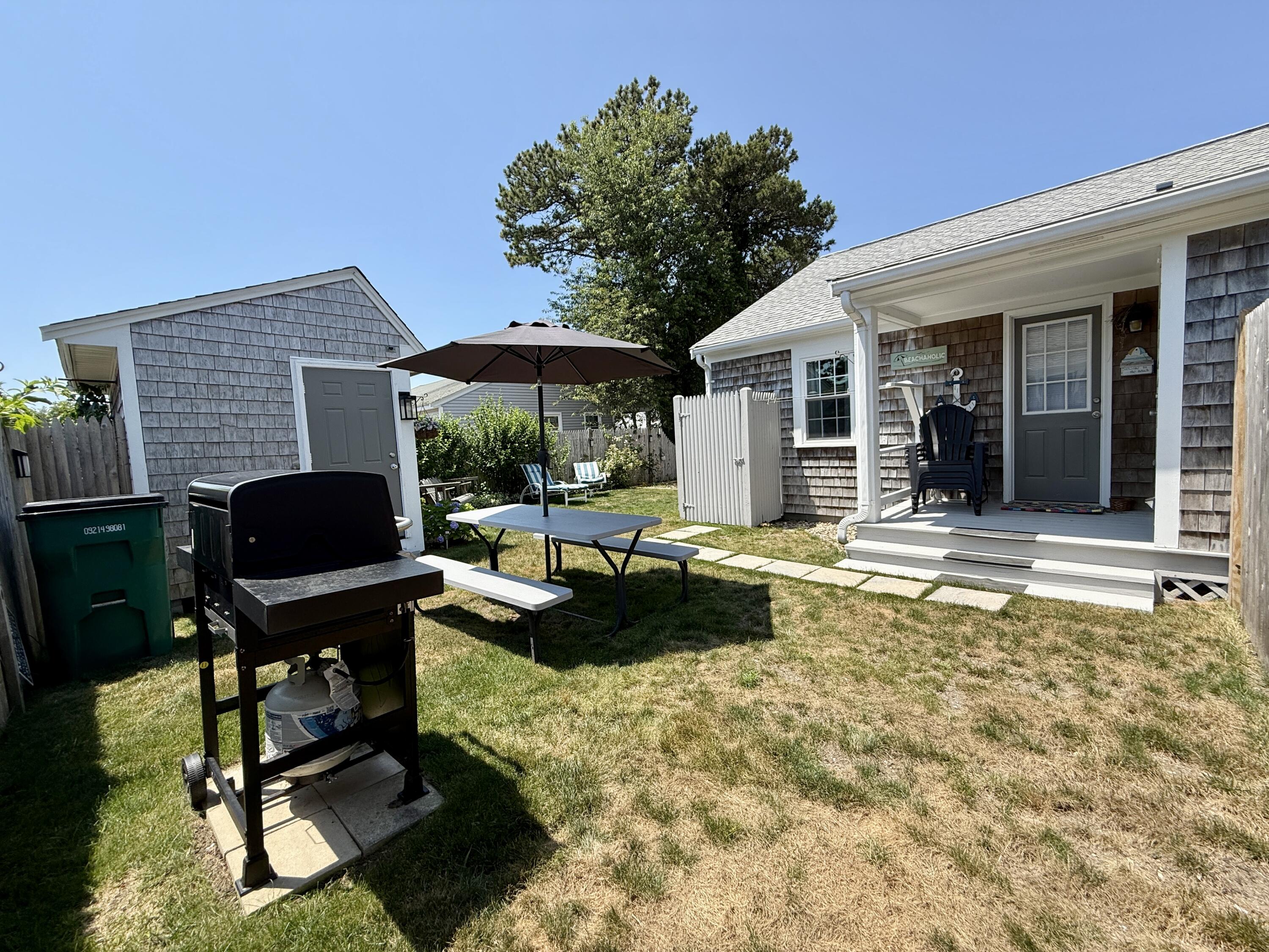 56-58 Uncle Rolf Road Dennis Port, MA 02639 - Photo 41 of 44 a view of a house with backyard porch and sitting area