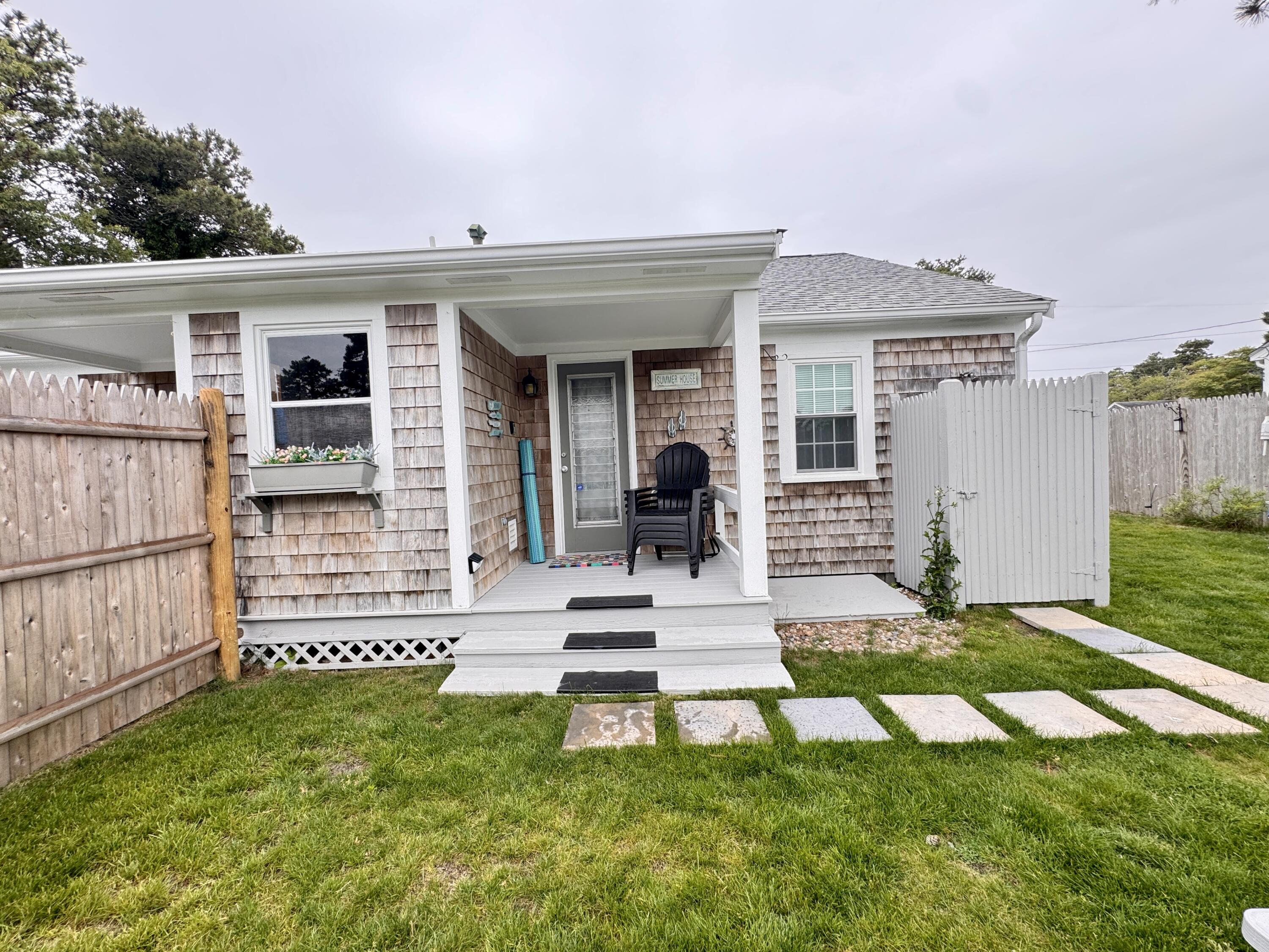 56-58 Uncle Rolf Road Dennis Port, MA 02639 - Photo 6 of 44 front view of a house with a yard