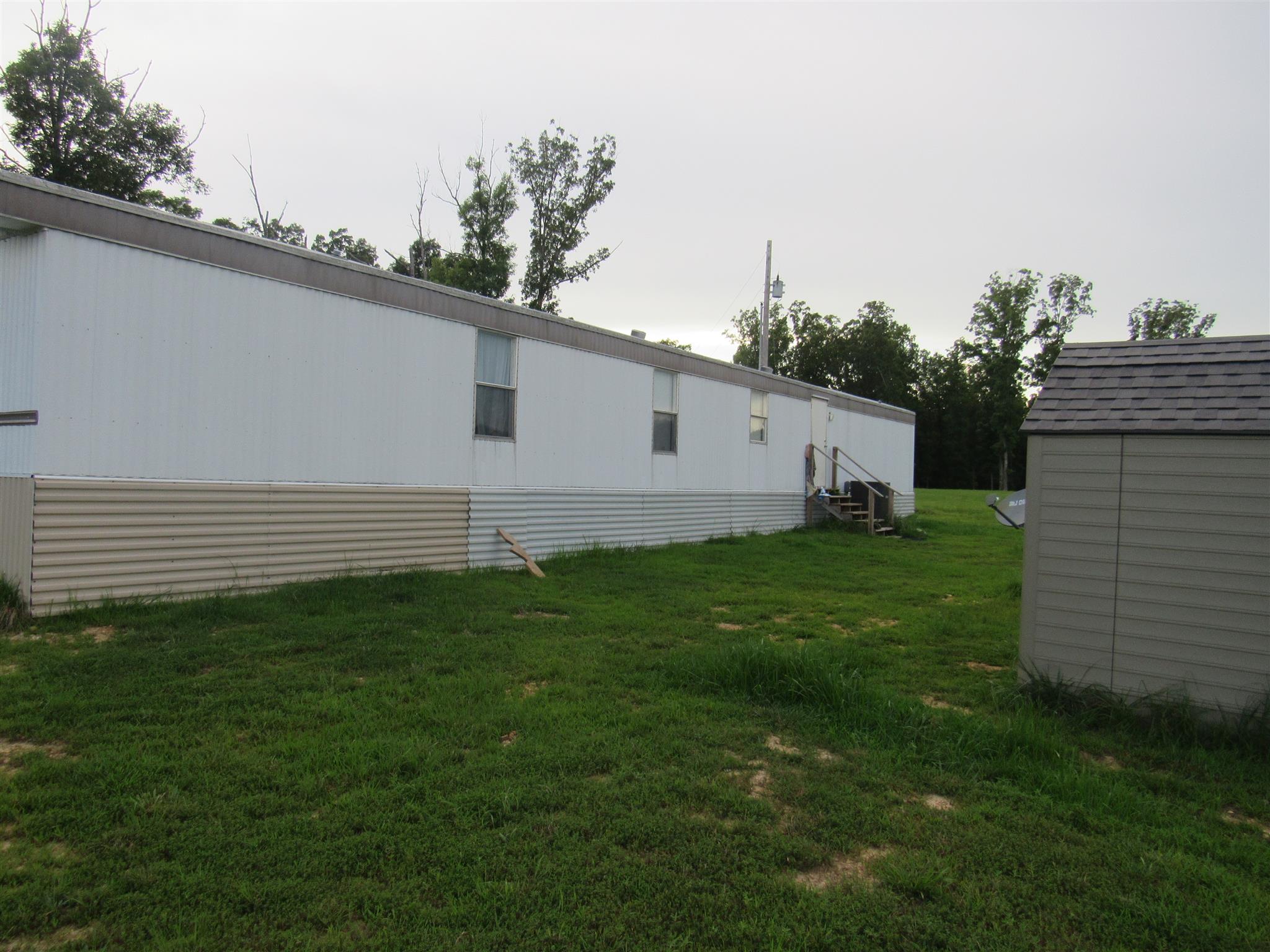 2050 CCC Road McEwen, TN 37101 - Photo 15 of 16 a view of a backyard with plants and large trees