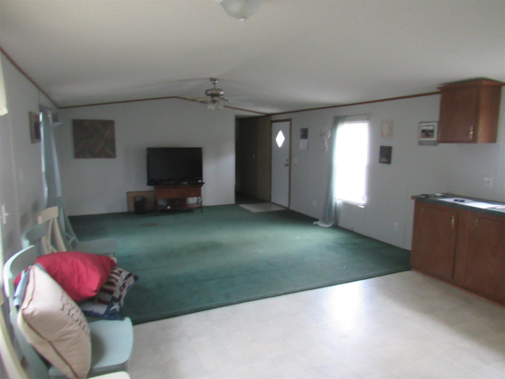 2050 CCC Road McEwen, TN 37101 - Photo 9 of 16 a living room with a fireplace and a flat screen tv