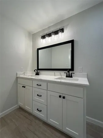 a bathroom with a sink vanity and mirror