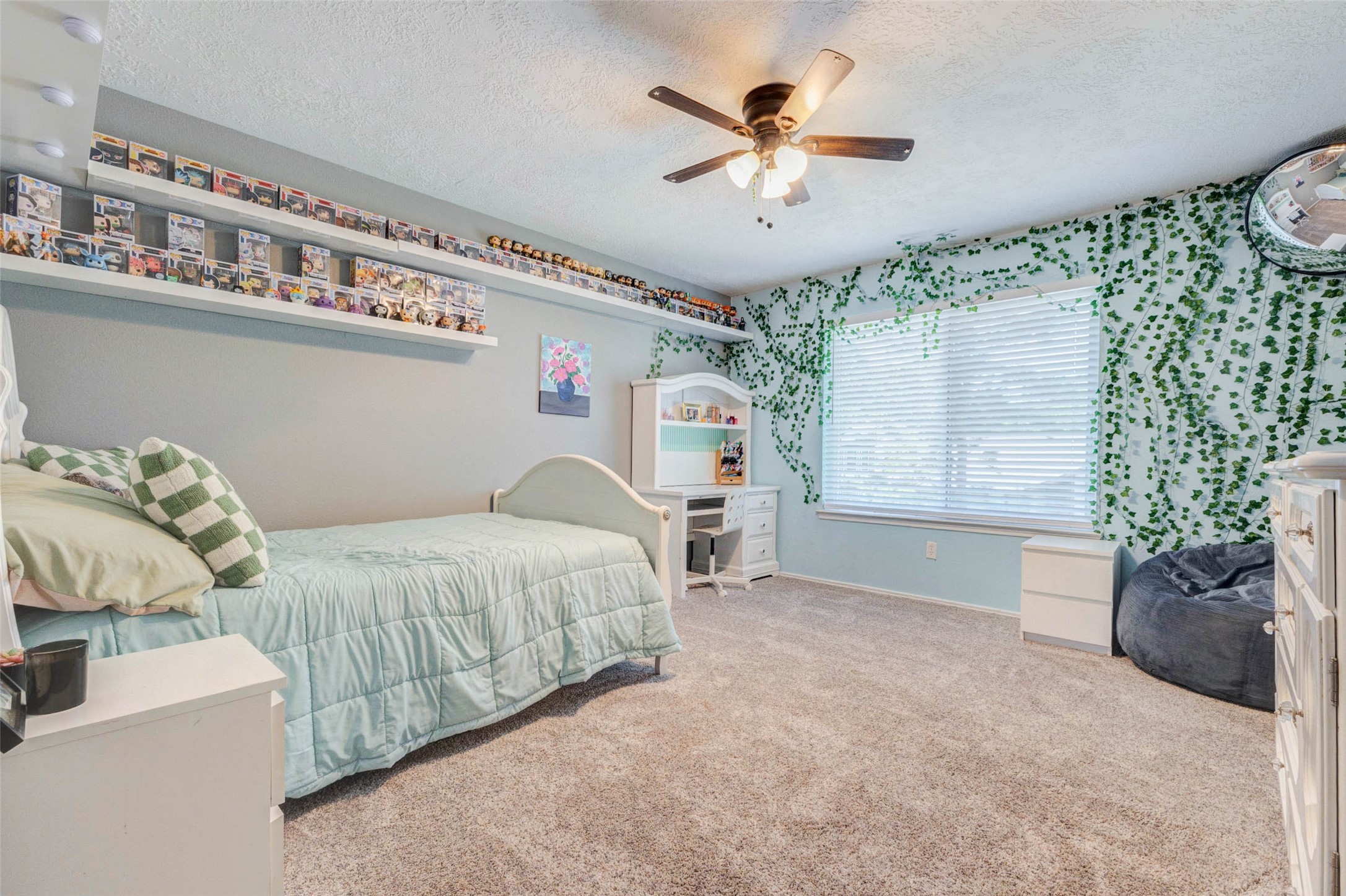9215 Landry Boulevard Spring, TX 77379 - Photo 33 of 42 Guest bedroom number three offers plush carpeting, a ceiling fan, and a large window that fills the space with natural light. Neutral tones and generous square footage provide flexibility for a bedroom, study area, or creative space.