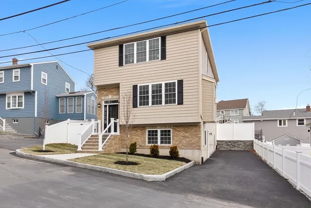 a view of a house with a swimming pool and sitting area
