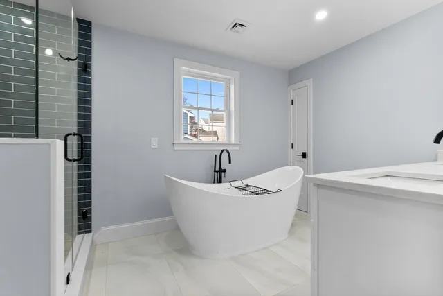 a white bath tub sitting next to a white sink
