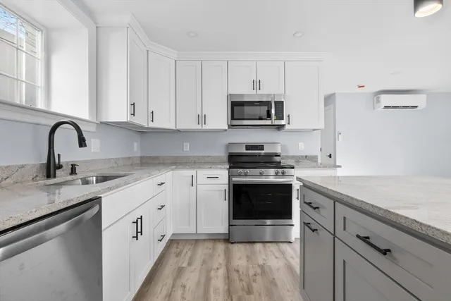 a bathroom with a tub sink vanity and shower