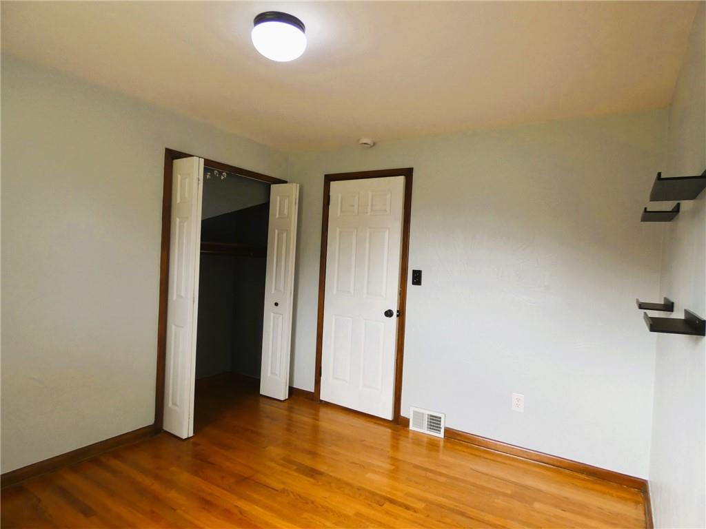 8459 Ridgemont Road Pittsburgh, PA 15237 - Photo 20 of 31 Bedroom 3 also features hardwood floors and wall shelving.