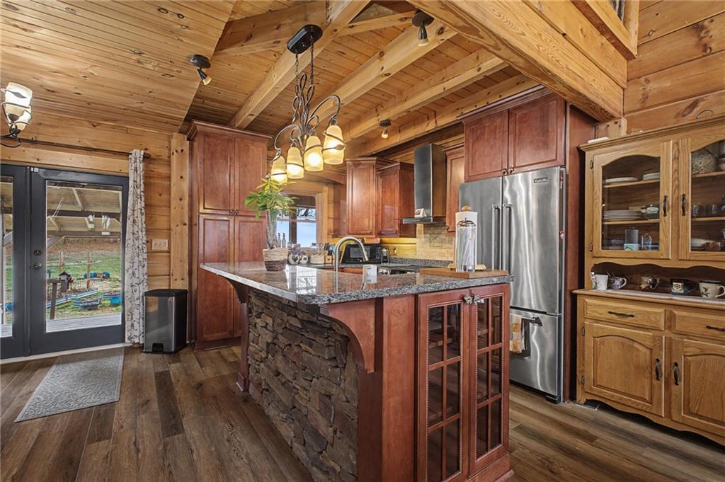 335 Bells Ferry Road Northeast Rome, GA 30161 - Photo 33 of 81 a kitchen with stainless steel appliances granite countertop a stove a refrigerator a sink dishwasher and wooden cabinets with wooden floor