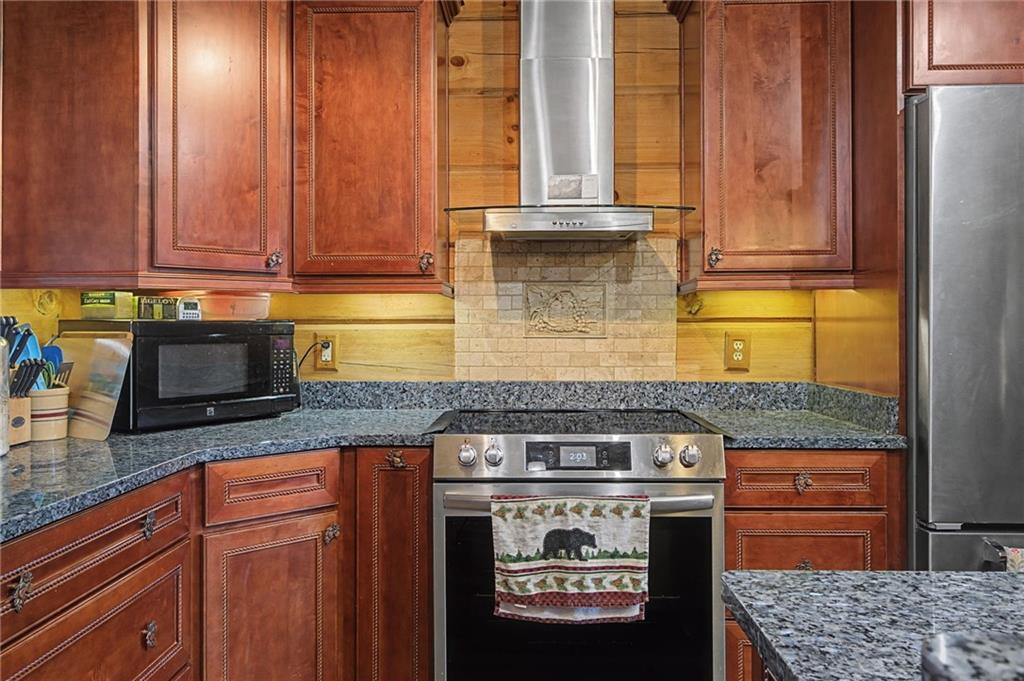 335 Bells Ferry Road Northeast Rome, GA 30161 - Photo 36 of 81 a kitchen with stainless steel appliances granite countertop a stove a sink and a microwave