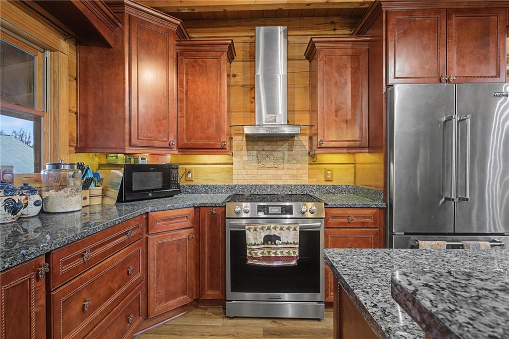 335 Bells Ferry Road Northeast Rome, GA 30161 - Photo 37 of 81 a kitchen with stainless steel appliances granite countertop a stove a refrigerator and a counter space