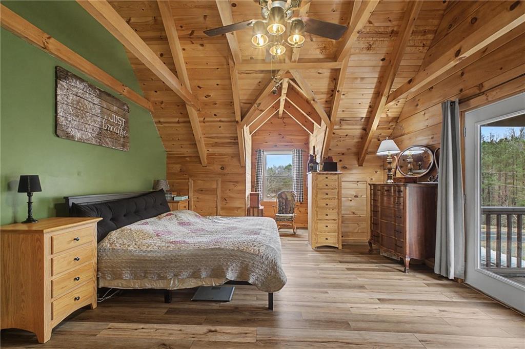 335 Bells Ferry Road Northeast Rome, GA 30161 - Photo 48 of 81 a bedroom with a large bed and a chandelier