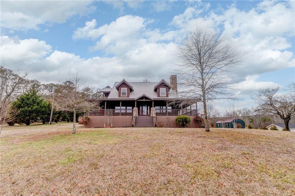 335 Bells Ferry Road Northeast Rome, GA 30161 - Photo 5 of 81 a front view of a house with a yard covered with snow