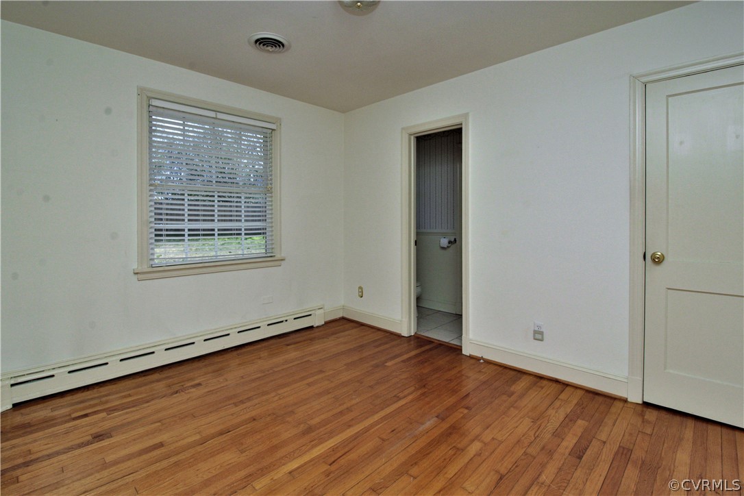 2931 Osborne Road Chester, VA 23831 - Photo 16 of 24 an empty room with wooden floor and windows