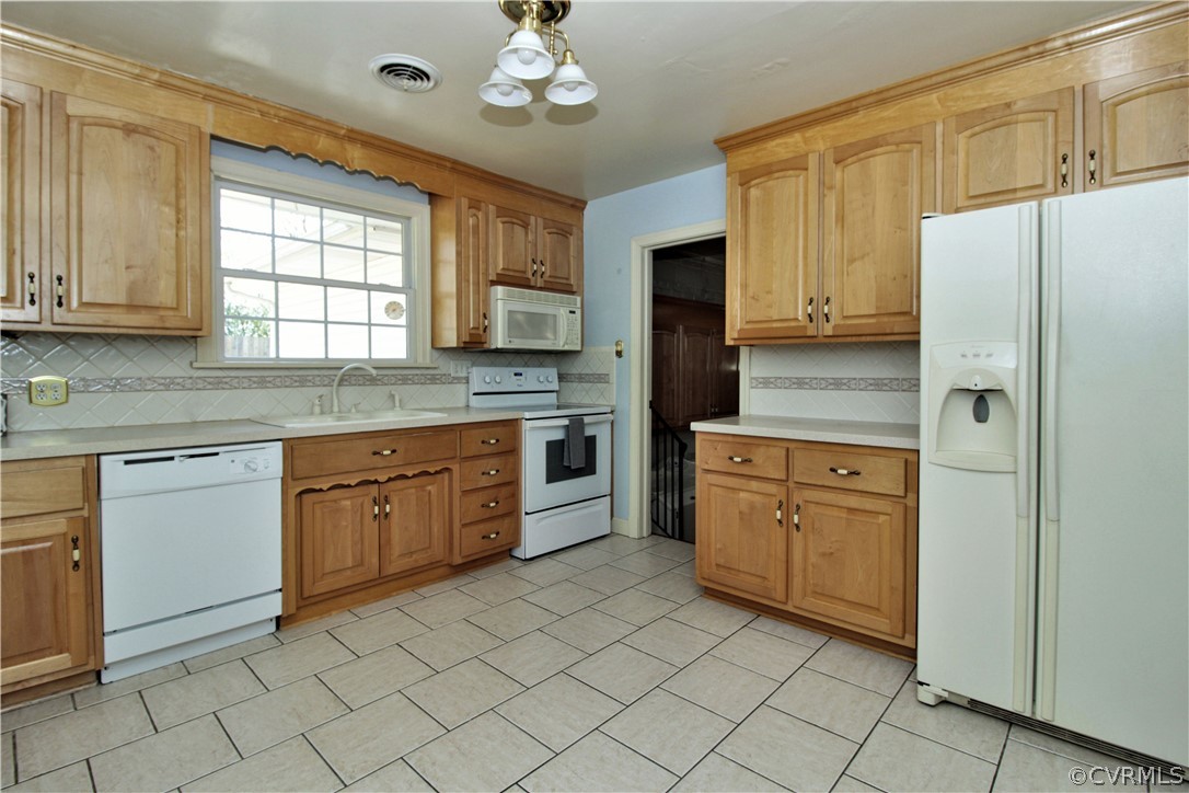 2931 Osborne Road Chester, VA 23831 - Photo 7 of 24 a kitchen with cabinets appliances and a window