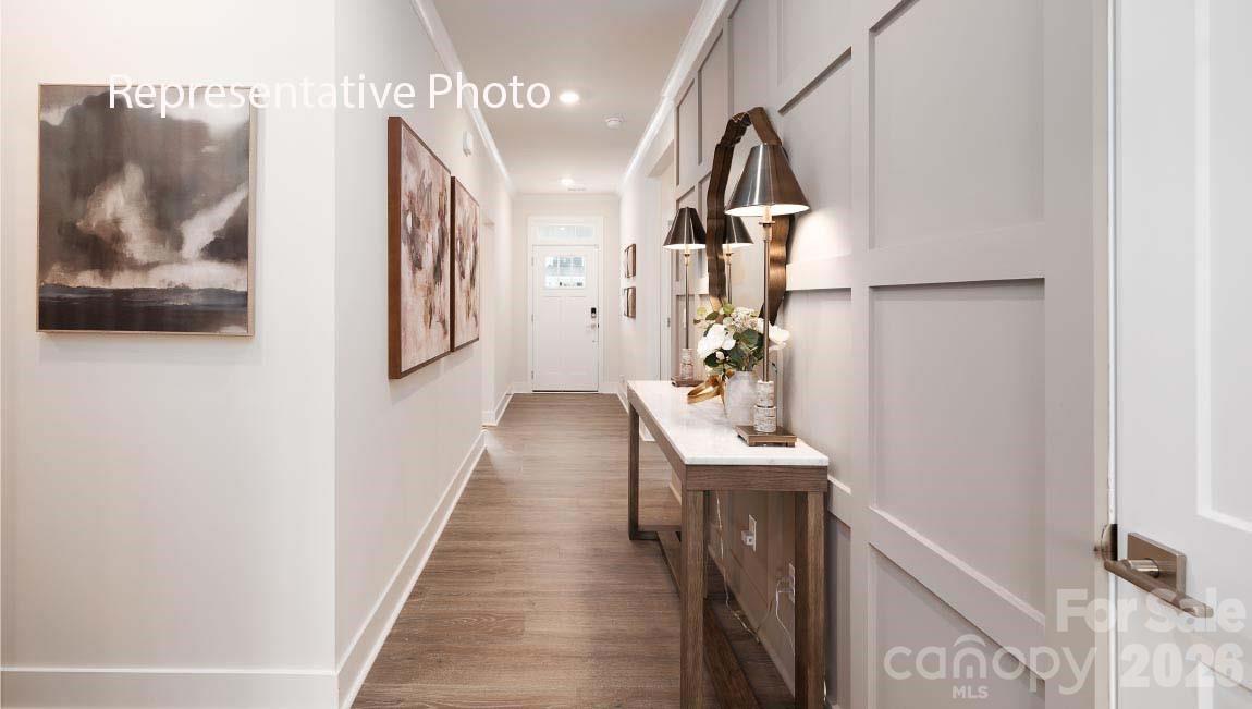 a view of entryway and hall with wooden floor