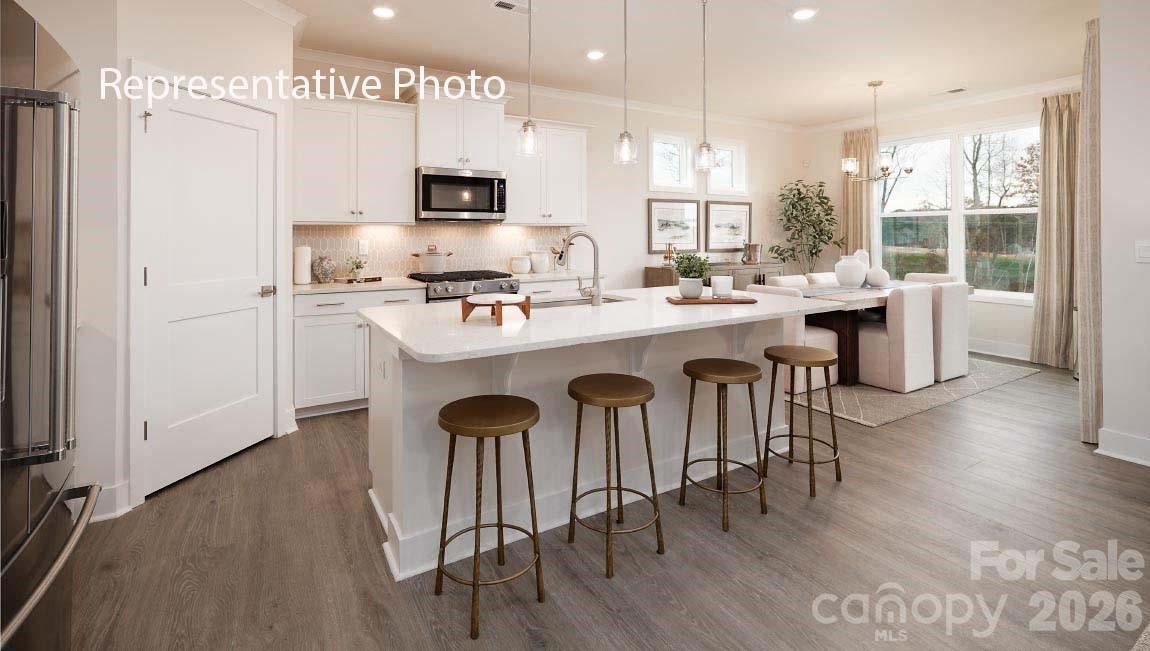 3221 Oberon Street York, SC 29745 - Photo 4 of 23 a kitchen with a sink a stove a refrigerator and a dining table