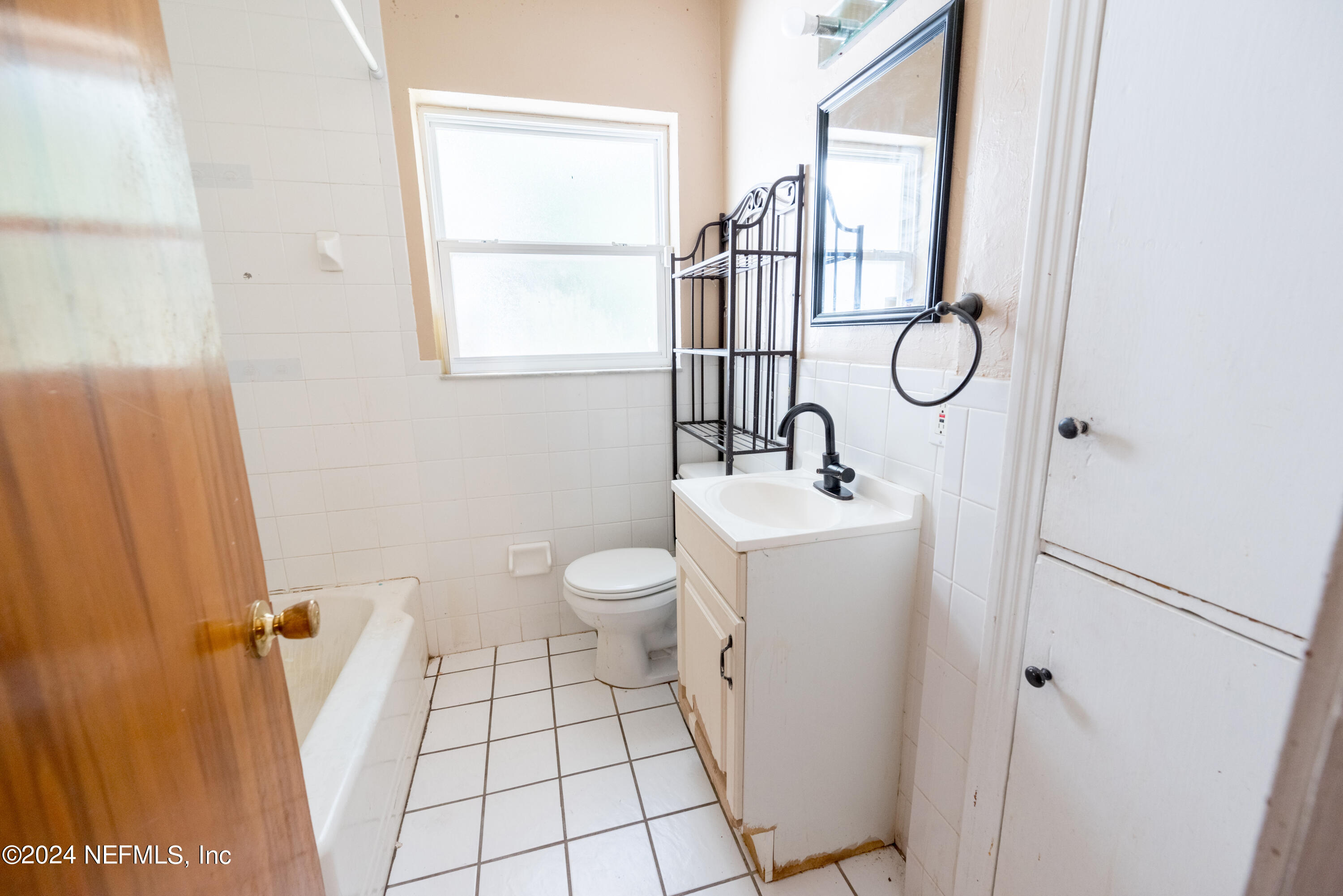 1122 West Pratt Street Starke, FL 32091 - Photo 18 of 22 a bathroom with a sink mirror vanity and toilet