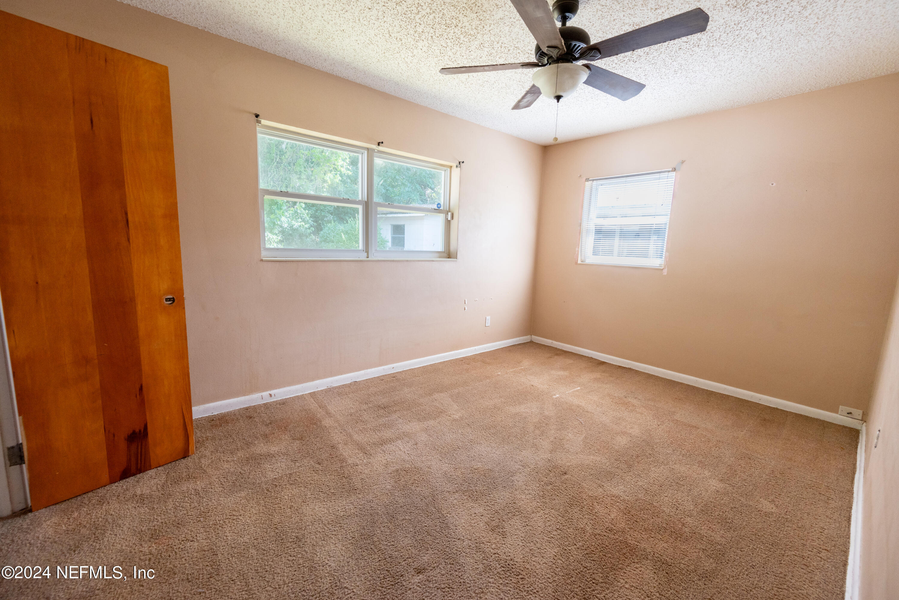 1122 West Pratt Street Starke, FL 32091 - Photo 20 of 22 an empty room with windows and fan