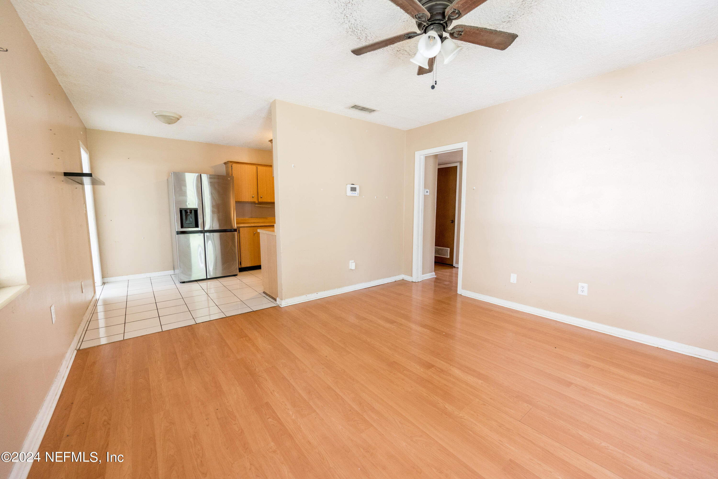 1122 West Pratt Street Starke, FL 32091 - Photo 3 of 22 a view of a livingroom with wooden floor and a ceiling fan