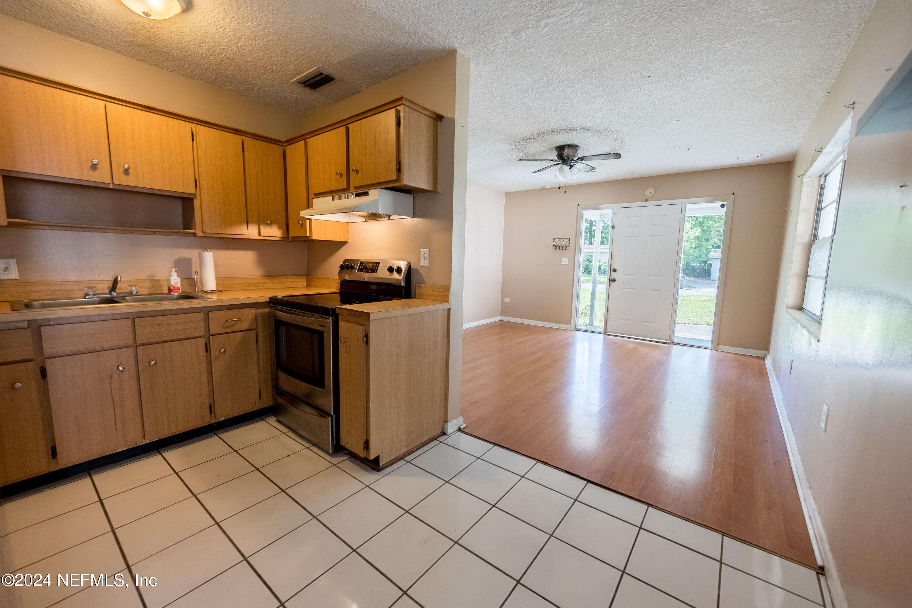 1122 West Pratt Street Starke, FL 32091 - Photo 8 of 22 a kitchen with stainless steel appliances granite countertop a sink stove and cabinets