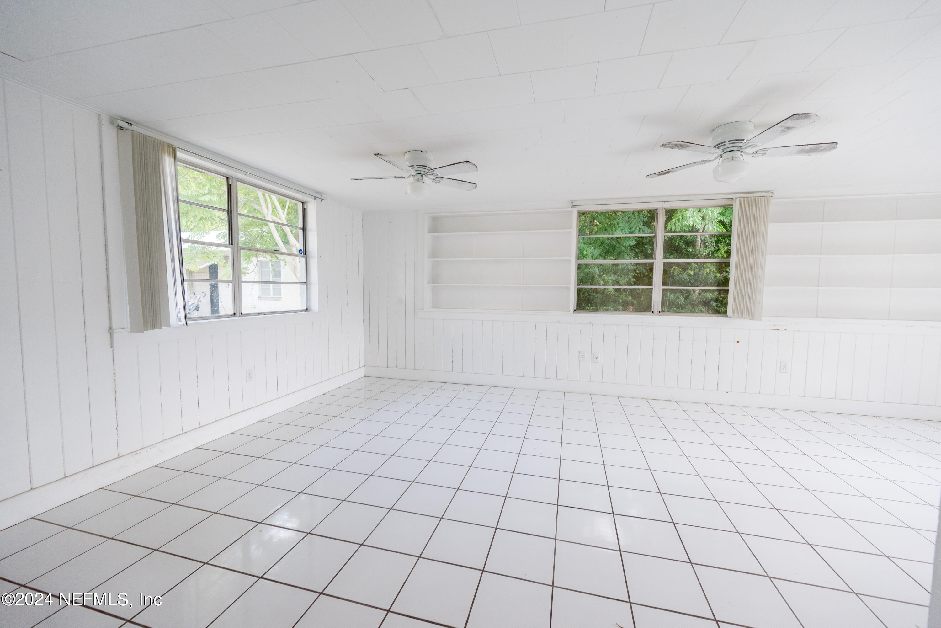 1122 West Pratt Street Starke, FL 32091 - Photo 9 of 22 an empty room with windows and fan