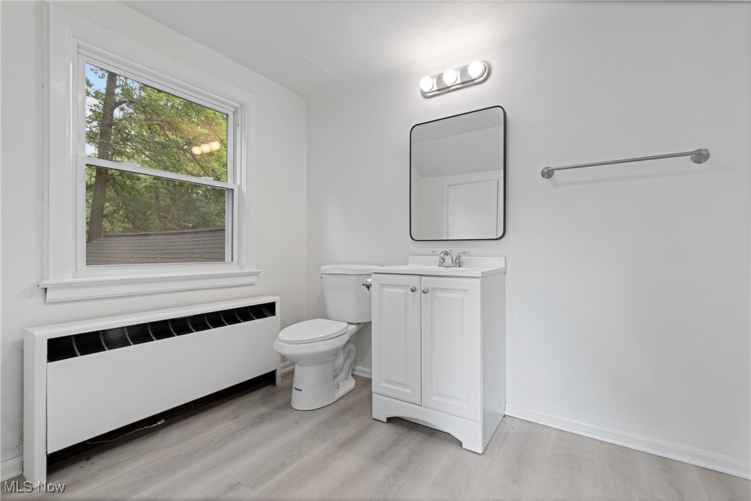 1057 Renfield Road Cleveland Heights, OH 44121 - Photo 23 of 30 Bathroom featuring toilet, hardwood / wood-style flooring, radiator, and vanity