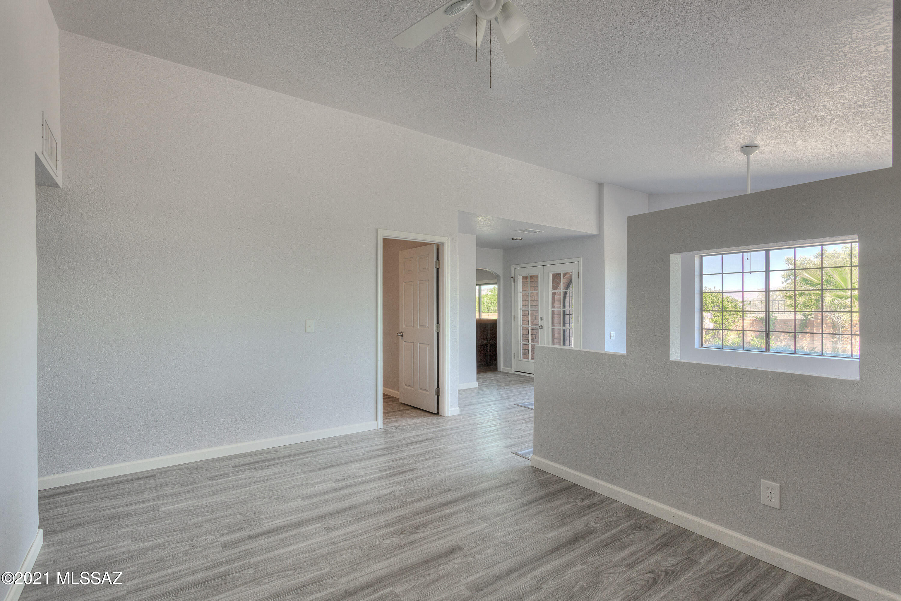 1096 Montosa Circulo Rio Rico, AZ 85648 - Photo 12 of 39 a view of an empty room with wooden floor and a window
