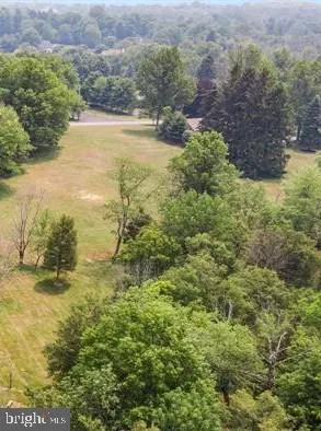 an aerial view of a houses with a yard