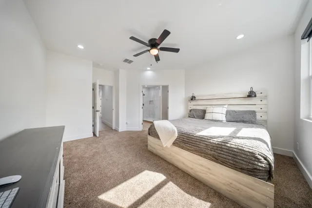 a bed room with a bed and a television