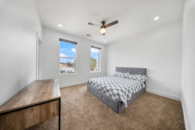 a bathroom with a double vanity sink toilet mirror and shower