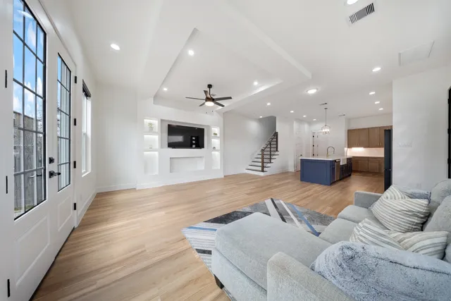 a living room with furniture and a wooden floor