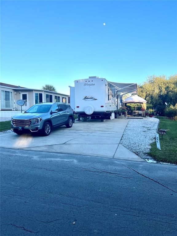 a wooden bench sitting in the middle of a yard