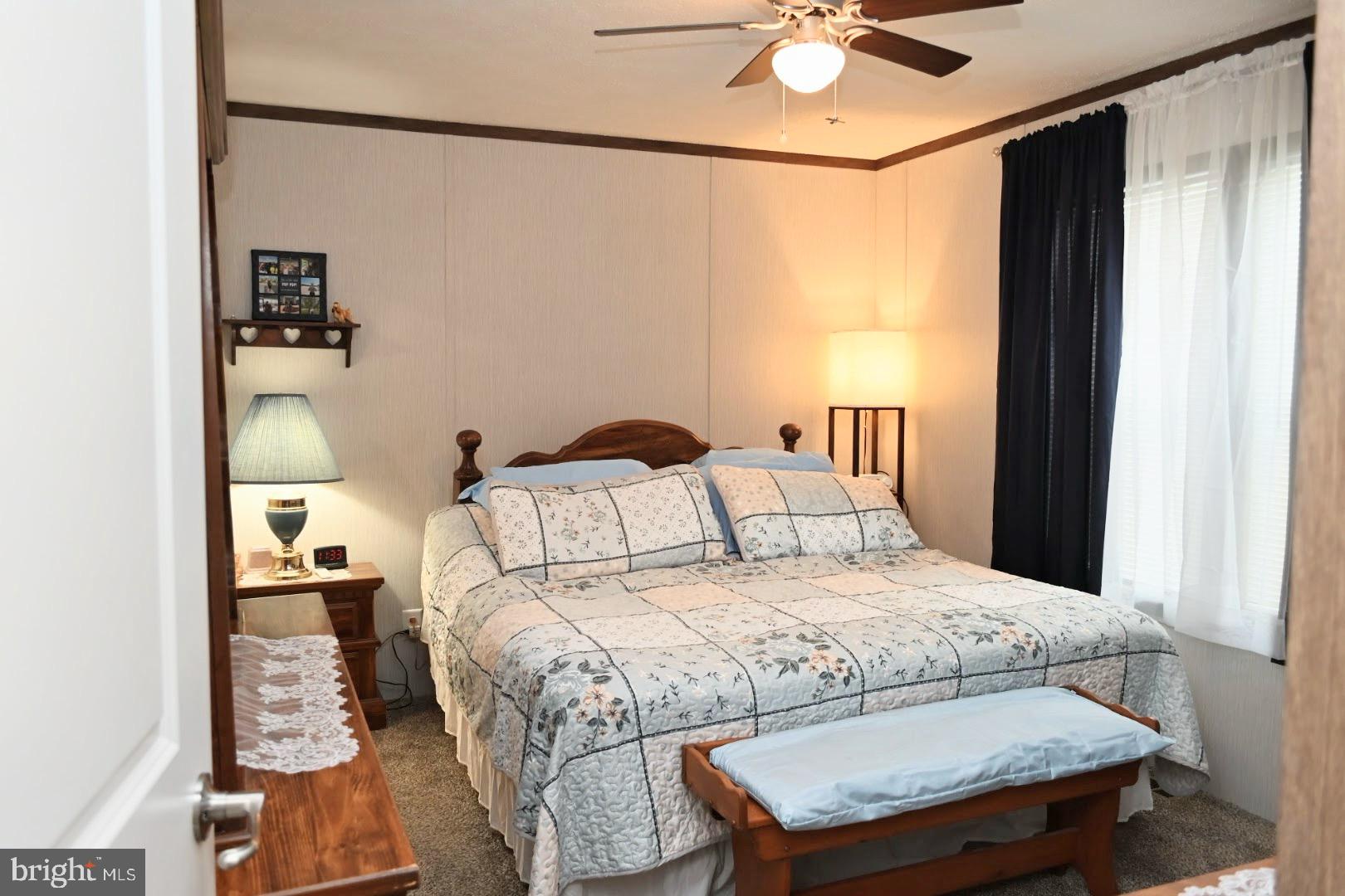 103 Carbridge Road East Stewartstown, PA 17363 - Photo 16 of 28 a bedroom with a bed and a chandelier