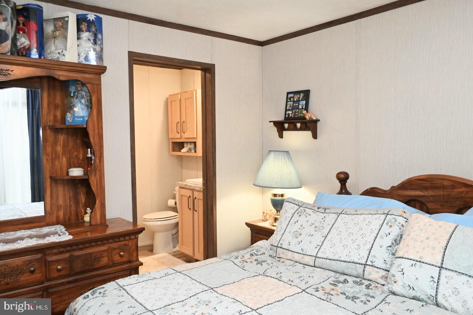 103 Carbridge Road East Stewartstown, PA 17363 - Photo 17 of 28 a bedroom with a bed and a mirror on the dresser