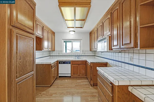 a kitchen with stainless steel appliances granite countertop a sink and cabinets