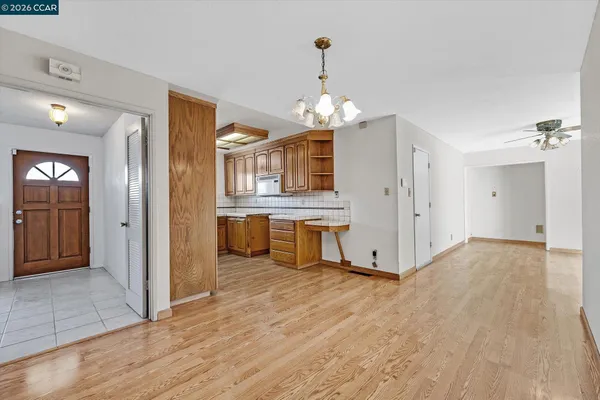 a view of a kitchen with a sink dishwasher cabinets and wooden floor