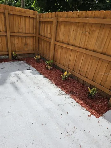 a view of a backyard with wooden fence