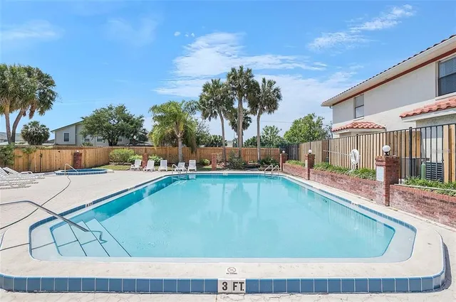 a swimming pool with outdoor seating and yard