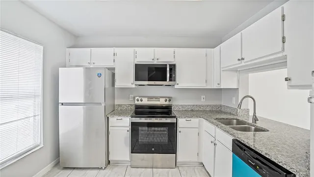 a kitchen with a refrigerator stove and sink