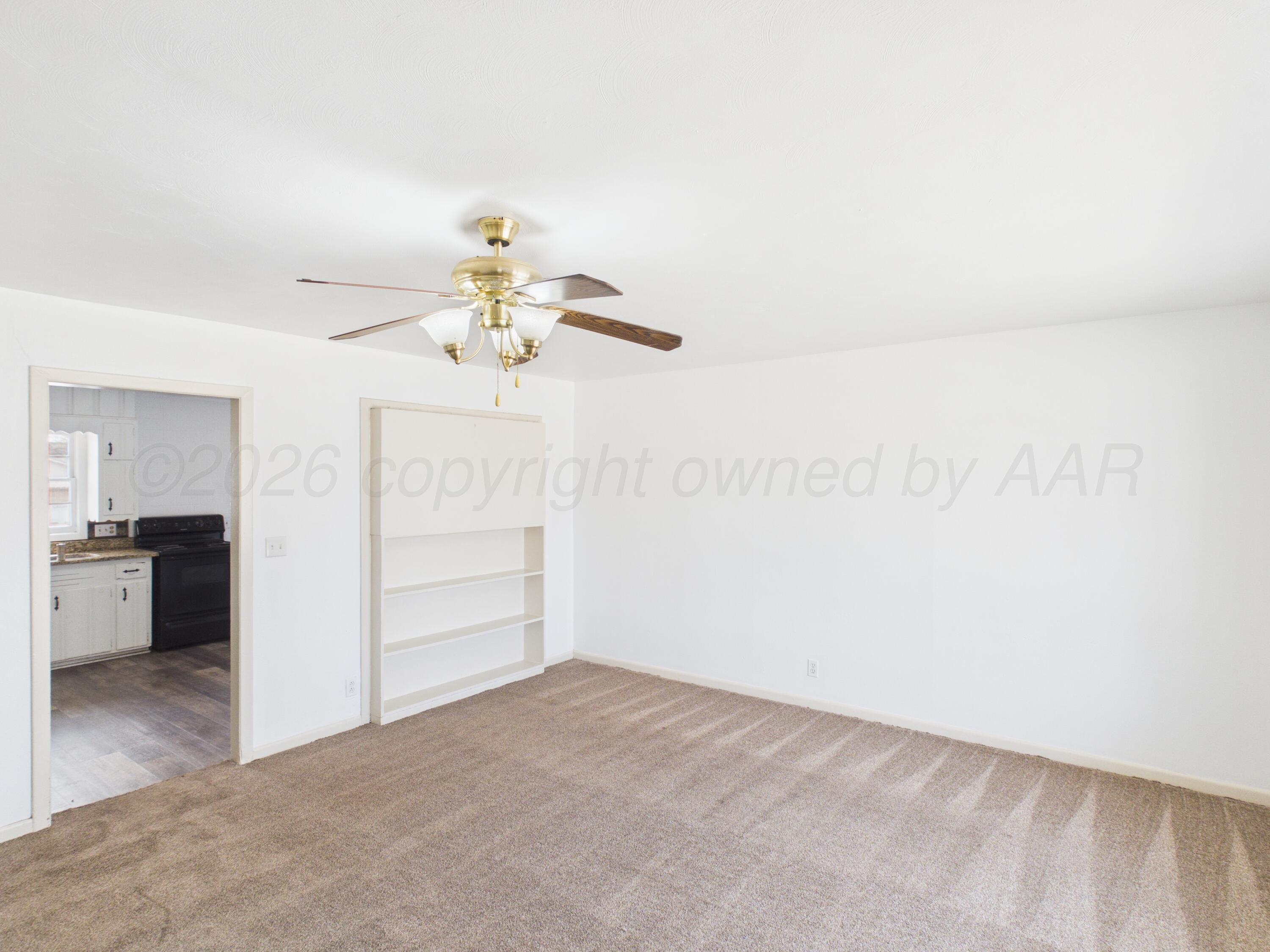 813 Northeast 3rd Street Dumas, TX 79029 - Photo 2 of 22 a view of a chandelier fan and entryway