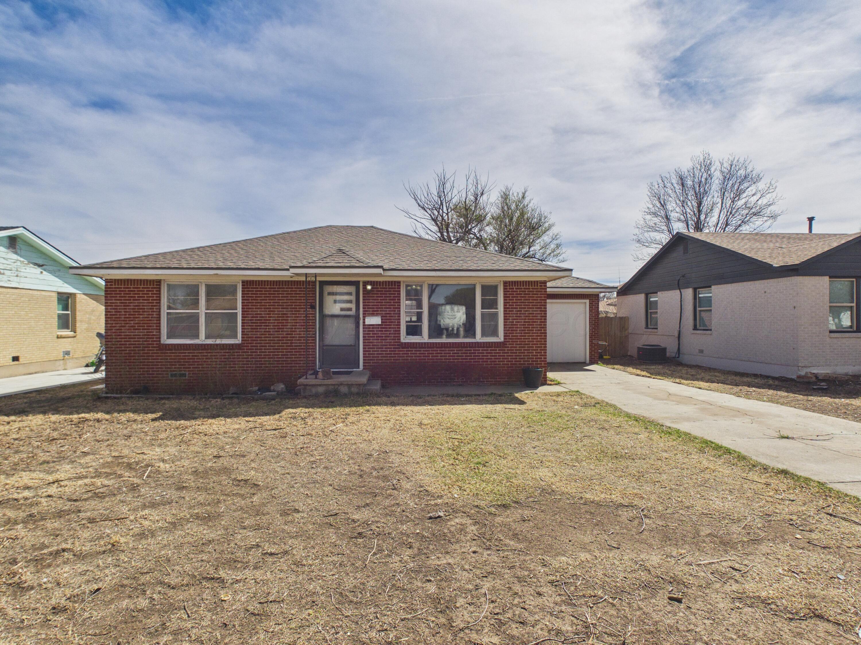 813 Northeast 3rd Street Dumas, TX 79029 - Photo 21 of 22 a front view of a house with a yard