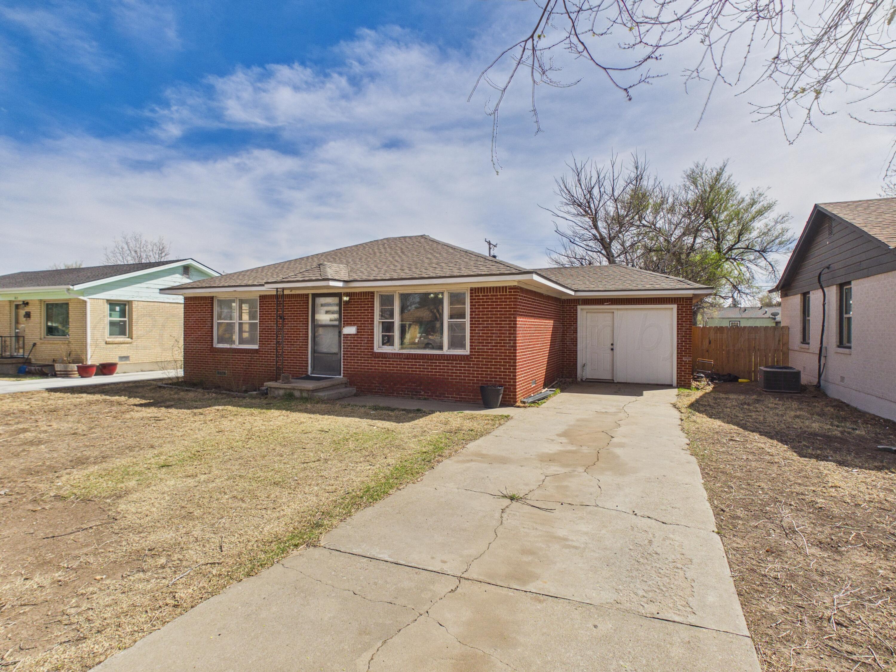 813 Northeast 3rd Street Dumas, TX 79029 - Photo 22 of 22 a front view of a house with a garden