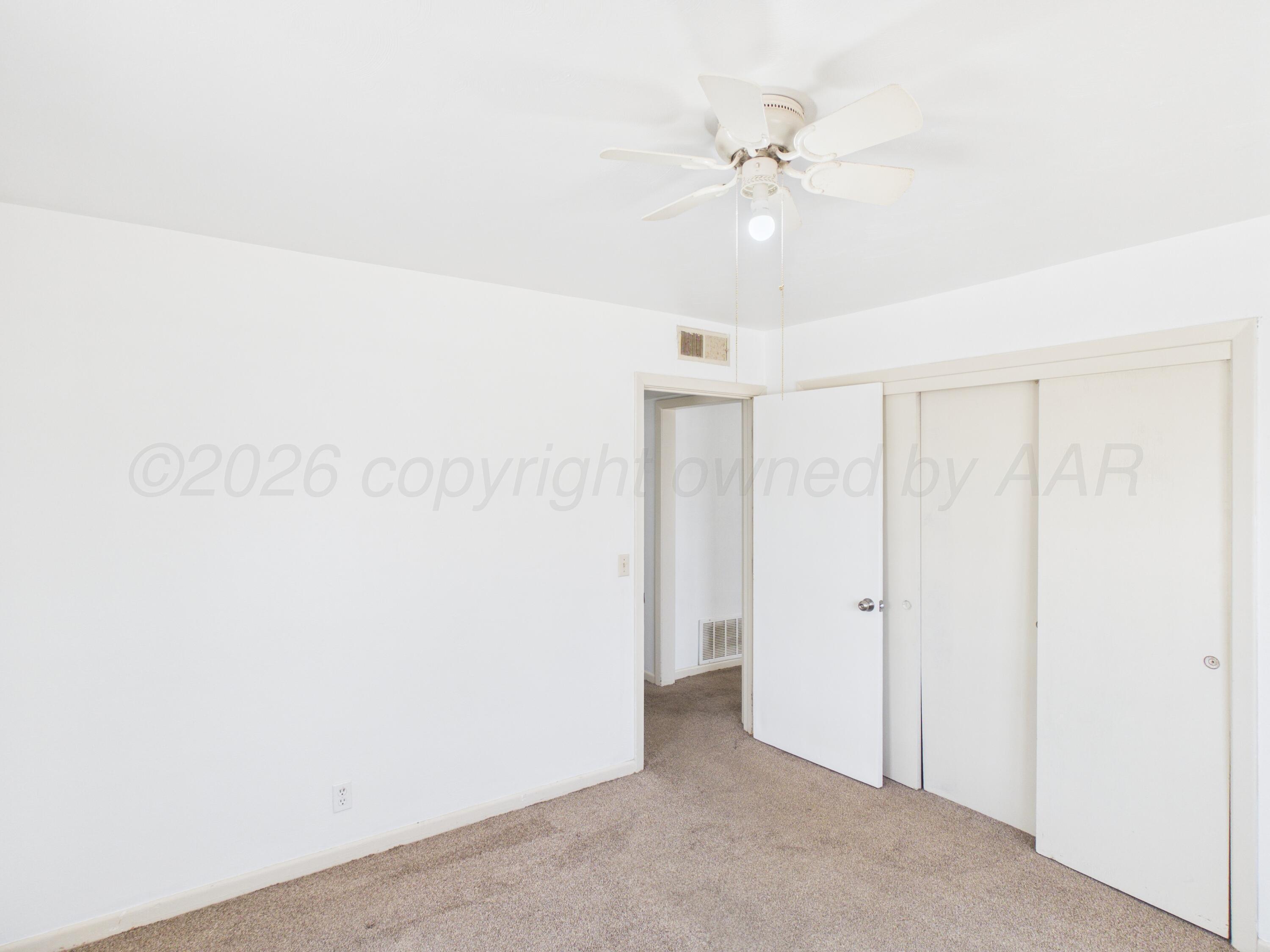 813 Northeast 3rd Street Dumas, TX 79029 - Photo 6 of 22 a view of a room with a ceiling fan