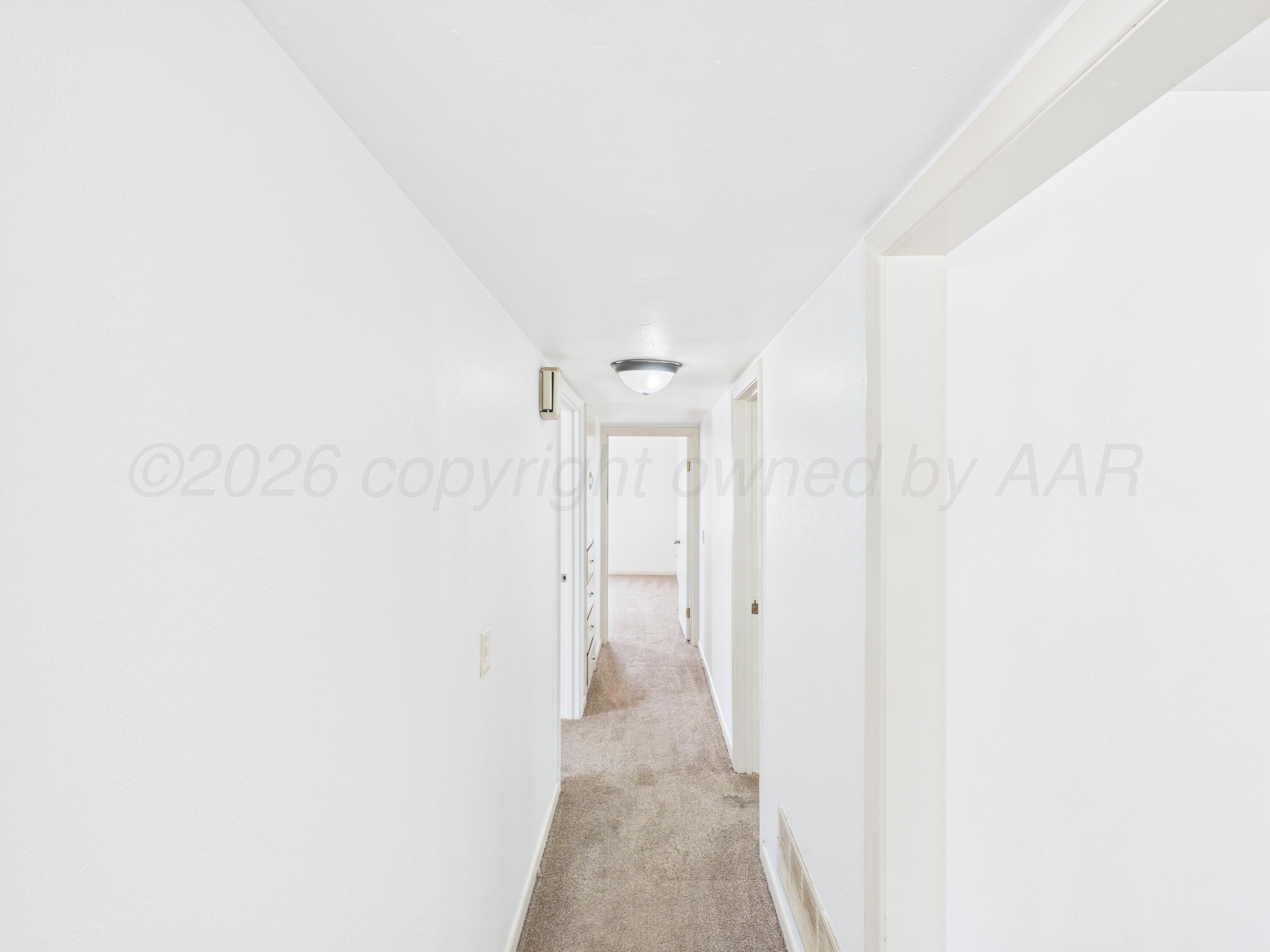 813 Northeast 3rd Street Dumas, TX 79029 - Photo 7 of 22 a view of a hallway