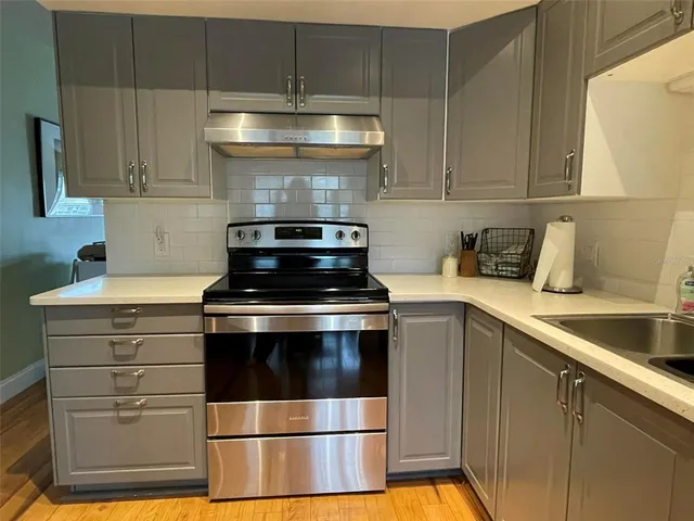 a stove top oven sitting inside of a kitchen