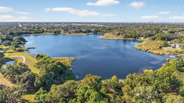 an aerial view of lake and residential houses with outdoor space