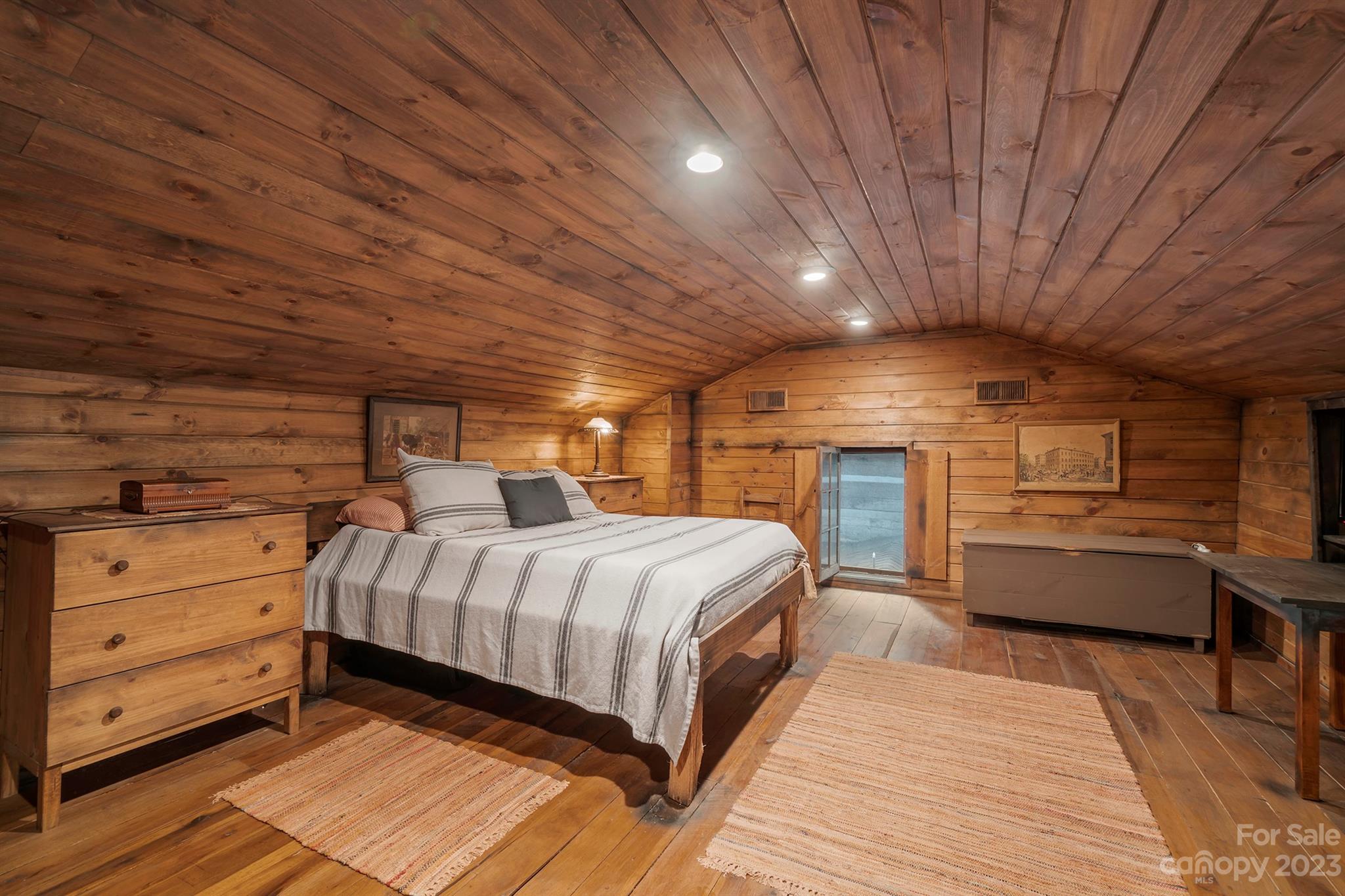 5646 Highway 18 Morganton, NC 28655 - Photo 29 of 37 a spacious bedroom with a bed and wooden floors